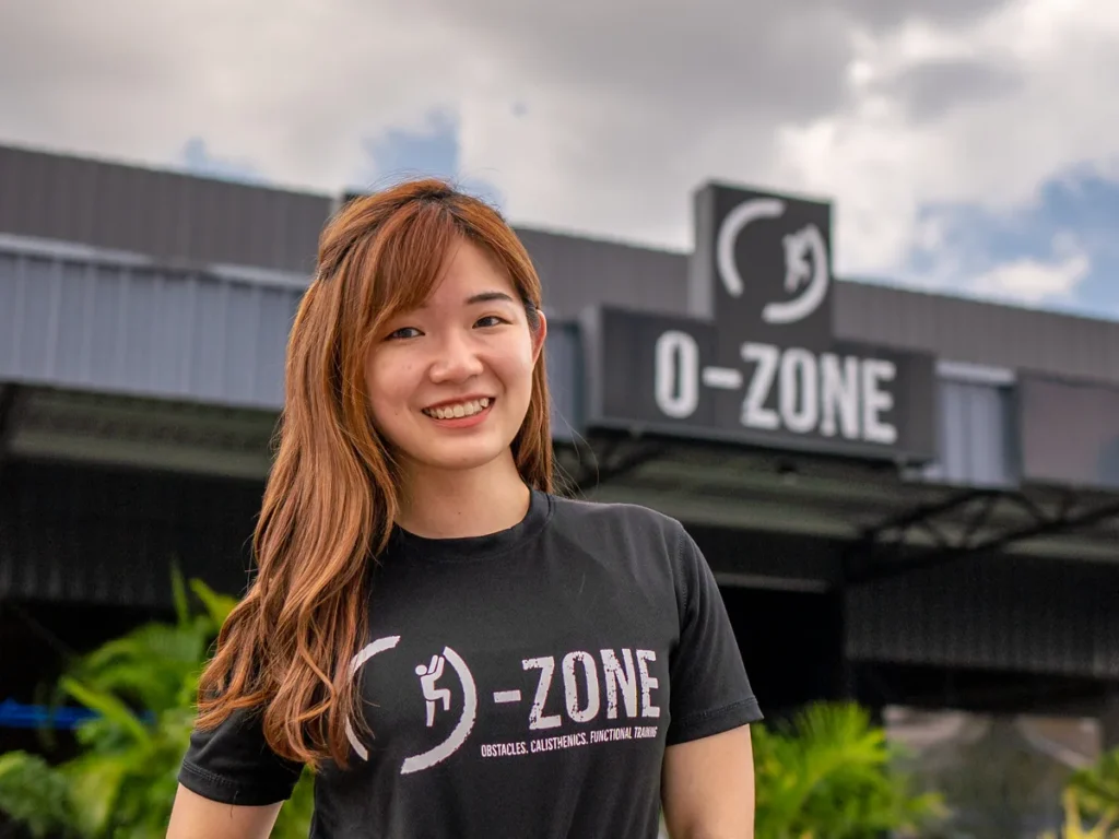 Yin Sinn smiling in front of the O-Zone gym entrance